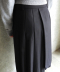 LAYERED PLEATED MIDI SKIRT